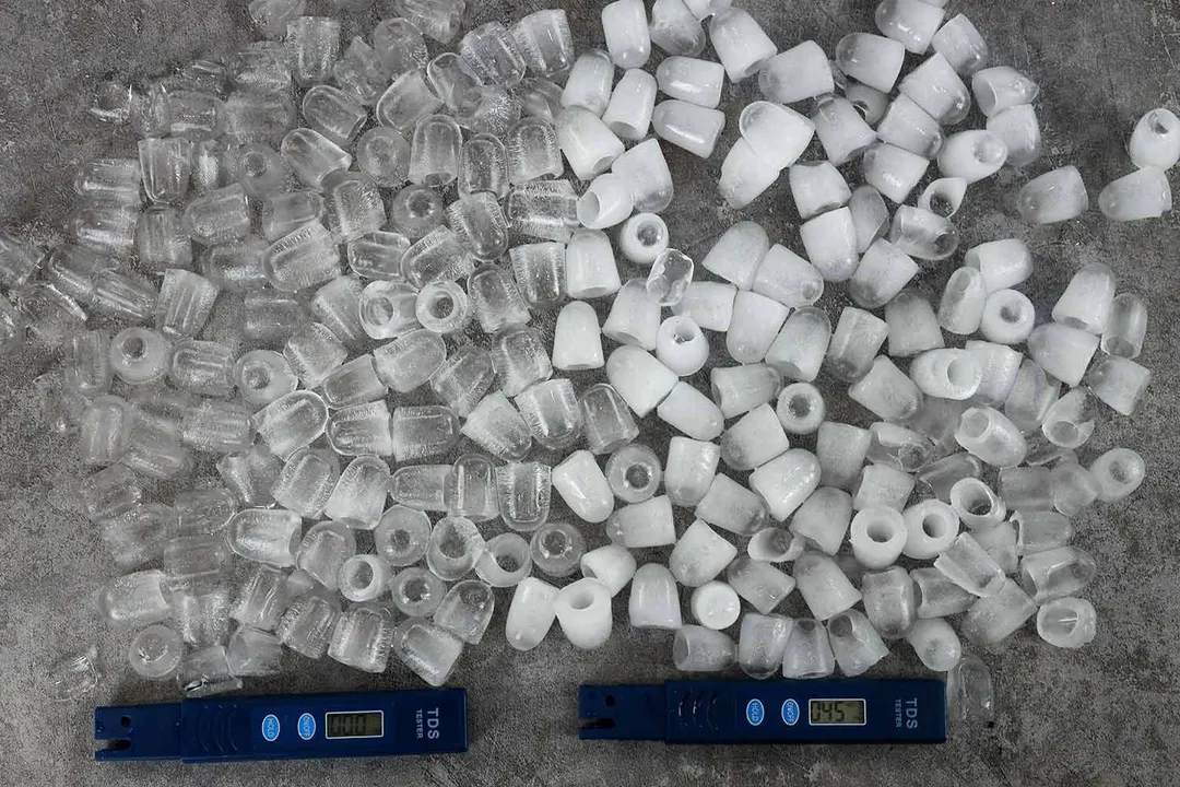 Two different batches of ice showing varying quality based on TDS levels as shown on two TDS meters.