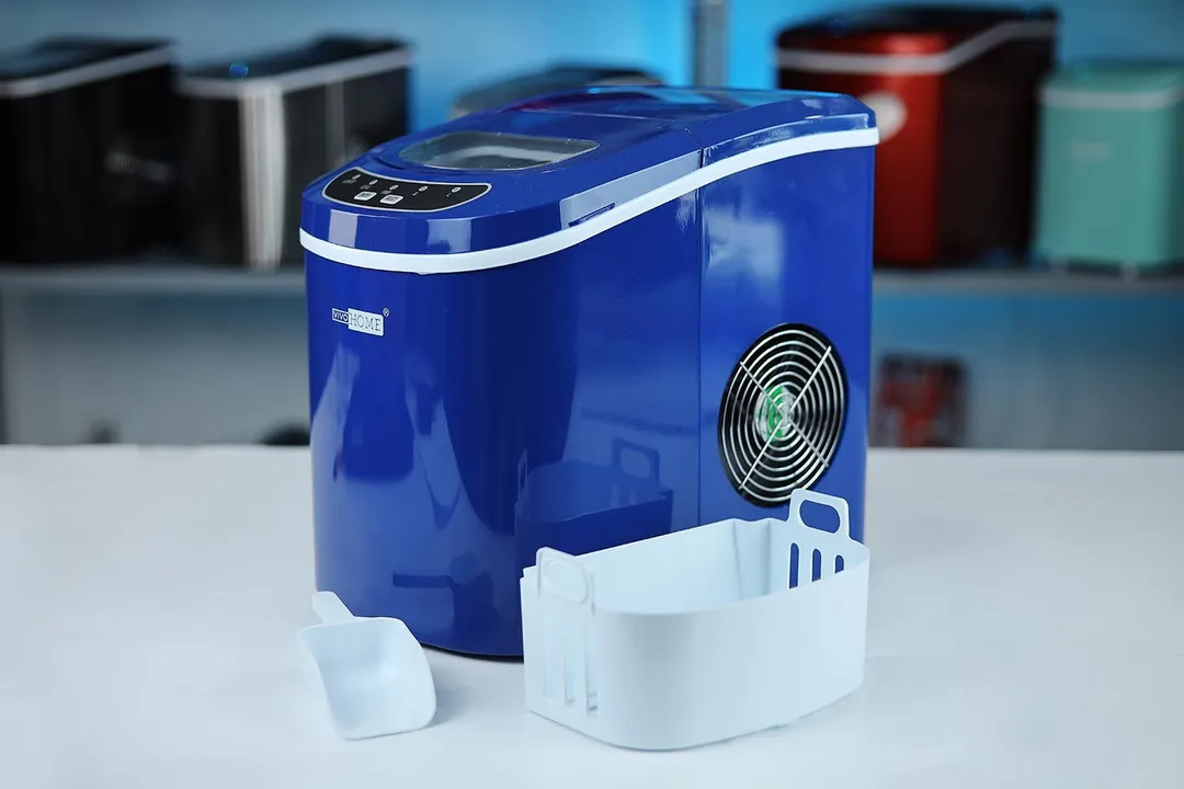 The navy blue Vivo Home portable ice maker pictured with the ice basket and ice scoop in front.