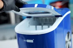 The lid of the Vivo Home countertop ice making machine being held up with black-gloved hand.
