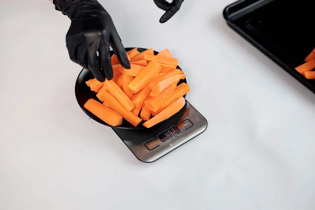 Carrot sticks being weighed on a food scale