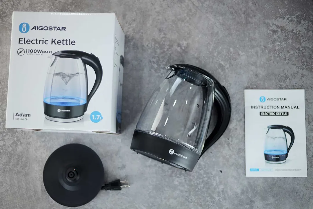 On the upper right is the Aigostar Electric Kettle 300104LCB. On the left is a cardboard box. Below the kettle, on the right is an instruction manual and on the left is the power base.