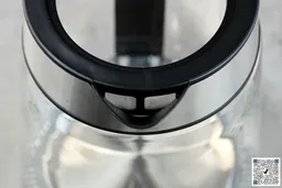 The mesh filter attached to the plastic black V-shaped spout of the Amazon Basics Electric Glass and Steel Kettle (F-625C).