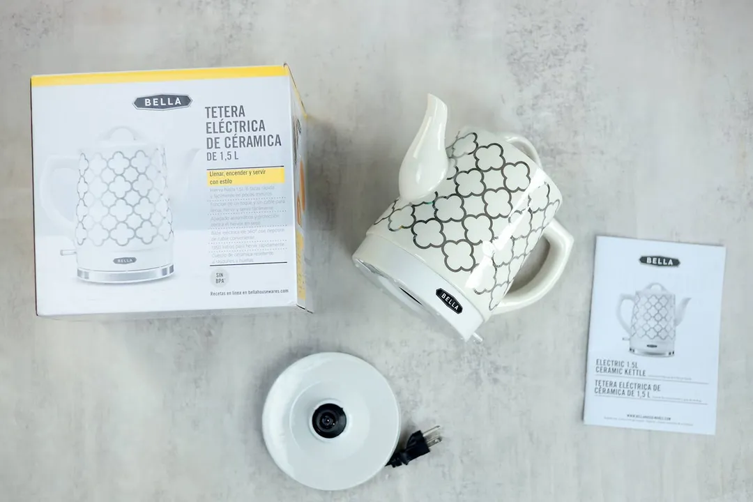 From the top down is a cardboard box, the power base, the Bella Ceramic Gooseneck Electric Kettle (14745), and the instruction manual.