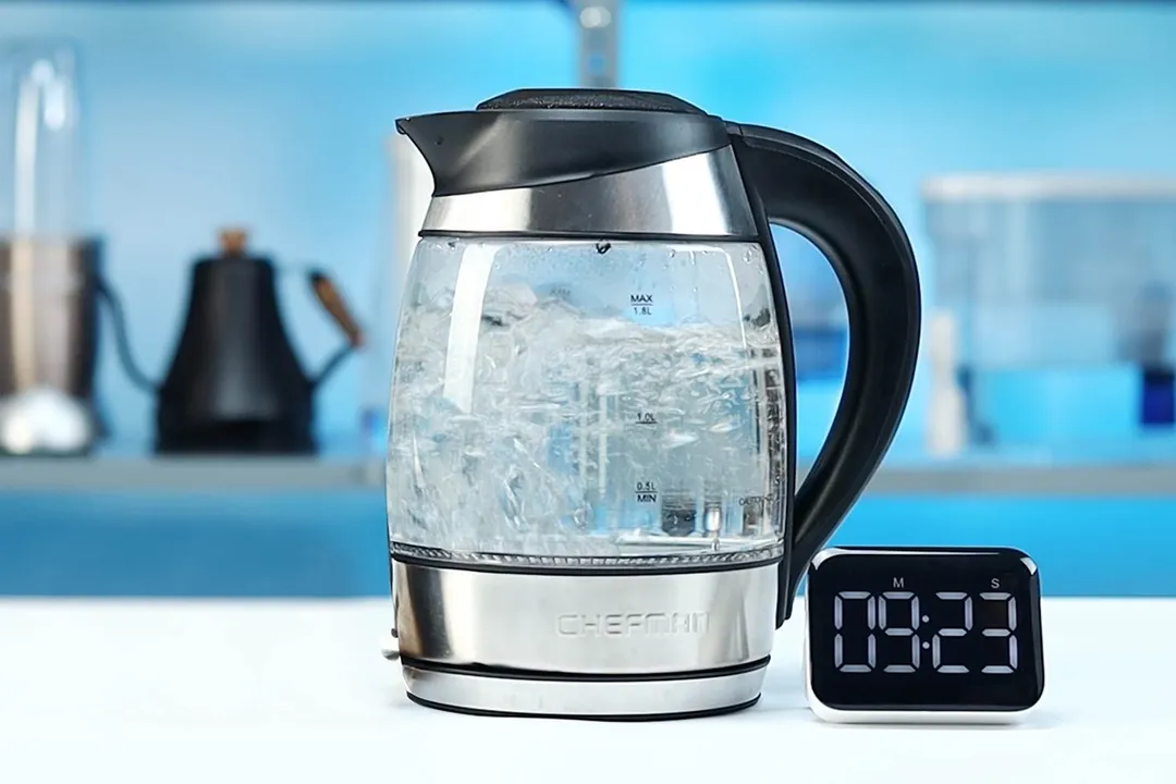 1.5 liter of water boiling inside the Chefman Electric Kettle with 5 Presets (RJ11-17-CTI-RL). The digital timer displays 9 minutes and 23 seconds.