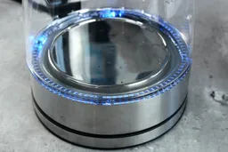 The heating plate with a LED ring around it glowing blue of the Comfee Glass Electric Kettle (CEKG003).