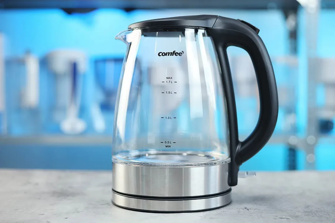 The carafe of the Comfee Glass Electric Kettle (CEKG003) sitting on top of its power base.