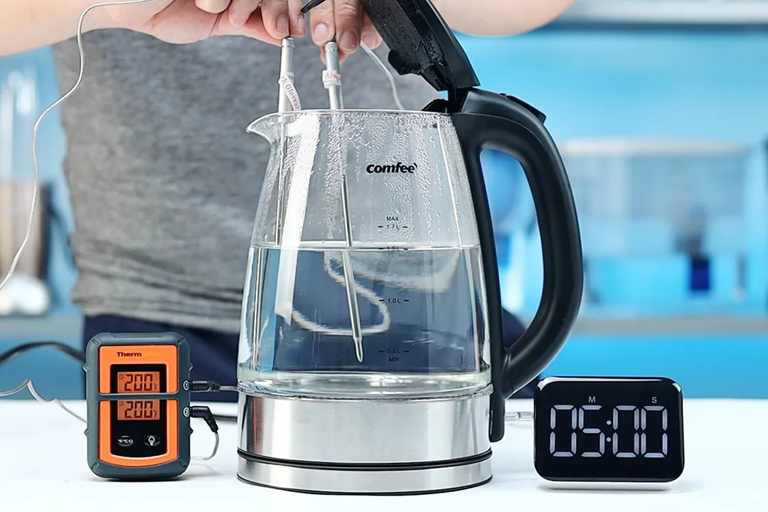 On the right is a Thermo Pro two-probe digital thermometer displaying 200°F for both probes. In the middle is the Comfee Glass Electric Kettle (CEKG003) with 1.5 liters of water and two probes inside. On the right is a digital timer displaying 5 minutes on the countdown.
