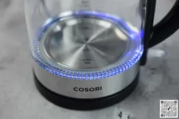The heating plate with a LED ring around it glowing blue of the Cosori Glass Electric Kettle (GK172-CO).