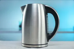 The carafe of the Cuisinart Stainless Steel Electric Kettle with 6 Preset Temperatures (CPK-17P1 PerfecTemp) sitting on top of its power base.