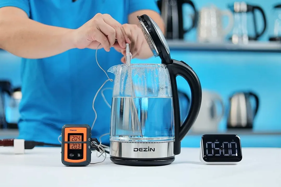 On the right is a Thermo Pro two-probe digital thermometer displaying 203°F and 204°F. In the middle is the Dezin Electric Glass Kettle DZ380 with 1.5 liters of water and two probes inside. On the right is a digital timer on a 5 minute countdown.