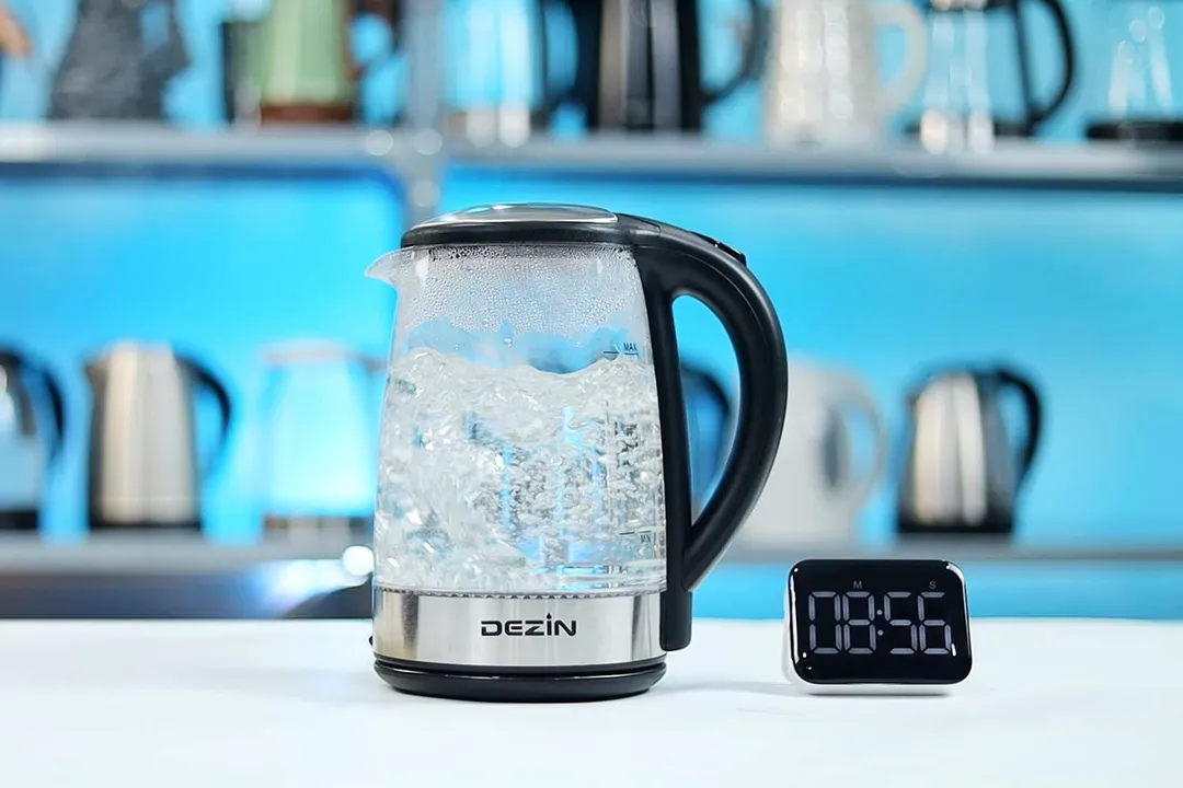 1.5 liters of water boiling inside the Dezin Electric Glass Kettle DZ380. The digital timer displays 08 minutes and 56 seconds.