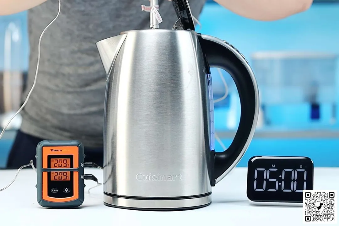 On the right is a Thermo Pro two-probe digital thermometer displaying 209°F for both probes. In the middle is the Cuisinart Stainless Steel Electric Kettle with 6 Preset Temperatures (CPK-17P1) with 1.5 liters of water and two probes inside. On the right is a digital timer displaying 5 minutes on the countdown.