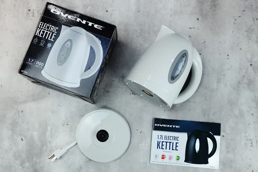 On the upper right is the Ovente Electric Kettle KP72W . On the left is a cardboard box. Below the kettle, on the right is an instruction manual and on the left is the power base.
