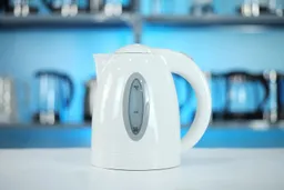 The carafe of the Ovente Electric Kettle KP72W sitting on top of its power base.
