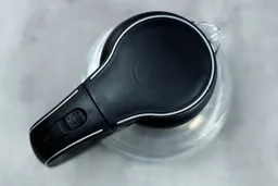 The black pop-up lid of the Ovente Electric Glass Kettle (KG83B).