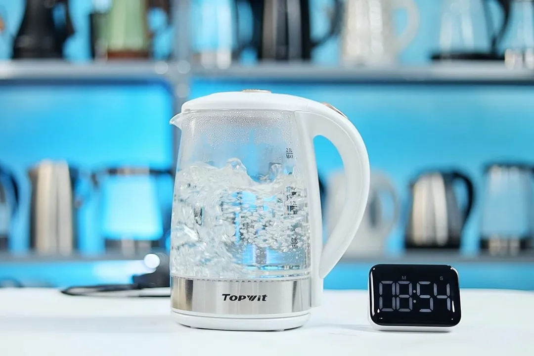 1.5 liters of water boiling inside the Topwit Glass Electric Tea Kettle T630. The digital timer displays 08 minutes and 54 seconds.