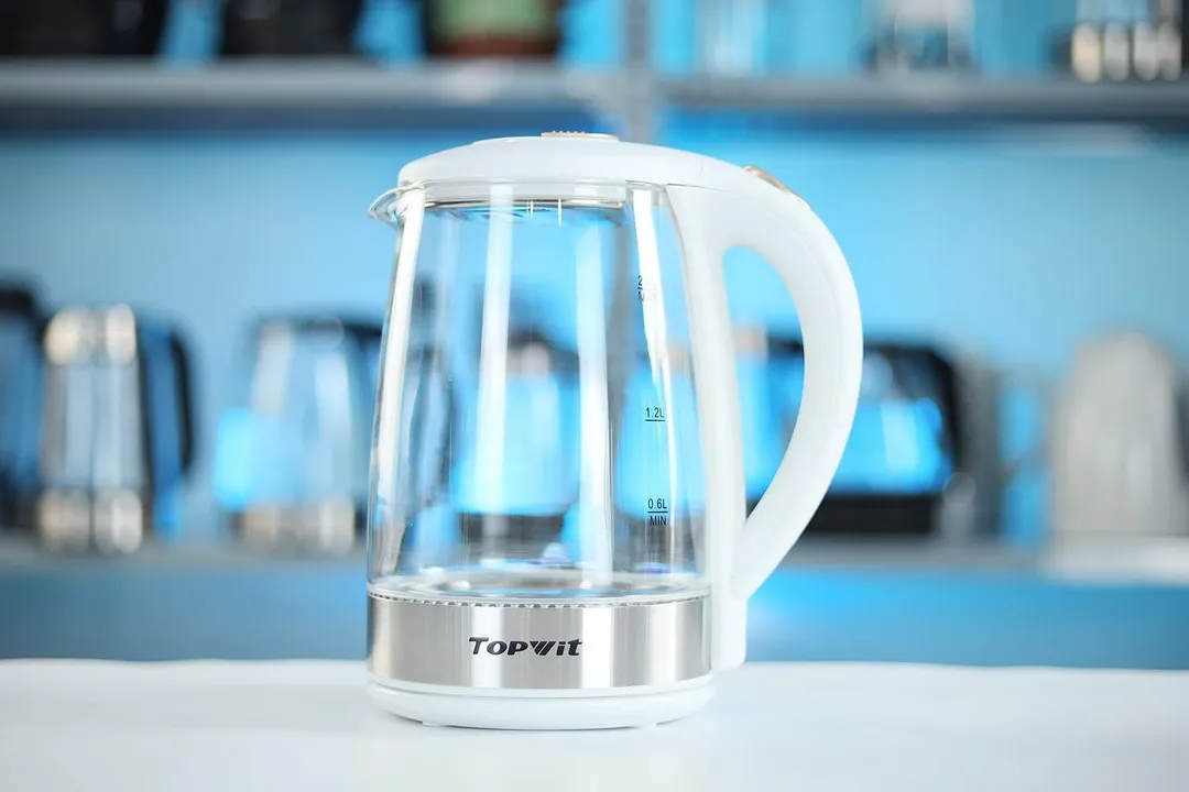 The carafe of the Topwit Glass Electric Tea Kettle T630 sitting on top of its power base.
