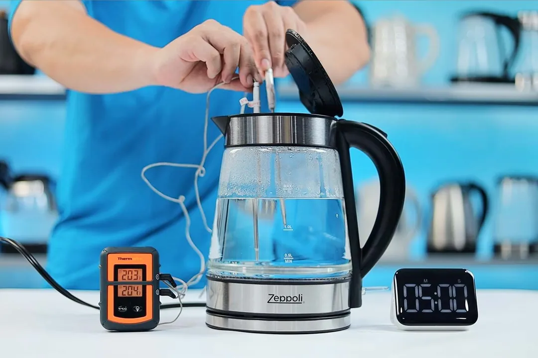 On the right is a Thermo Pro two-probe digital thermometer displaying 203°F and 204°F. In the middle is the Zeppoli Electric Kettle ZPL-KETTLE with 1.5 liters of water and two probes inside. On the right is a digital timer on a 5 minute countdown.