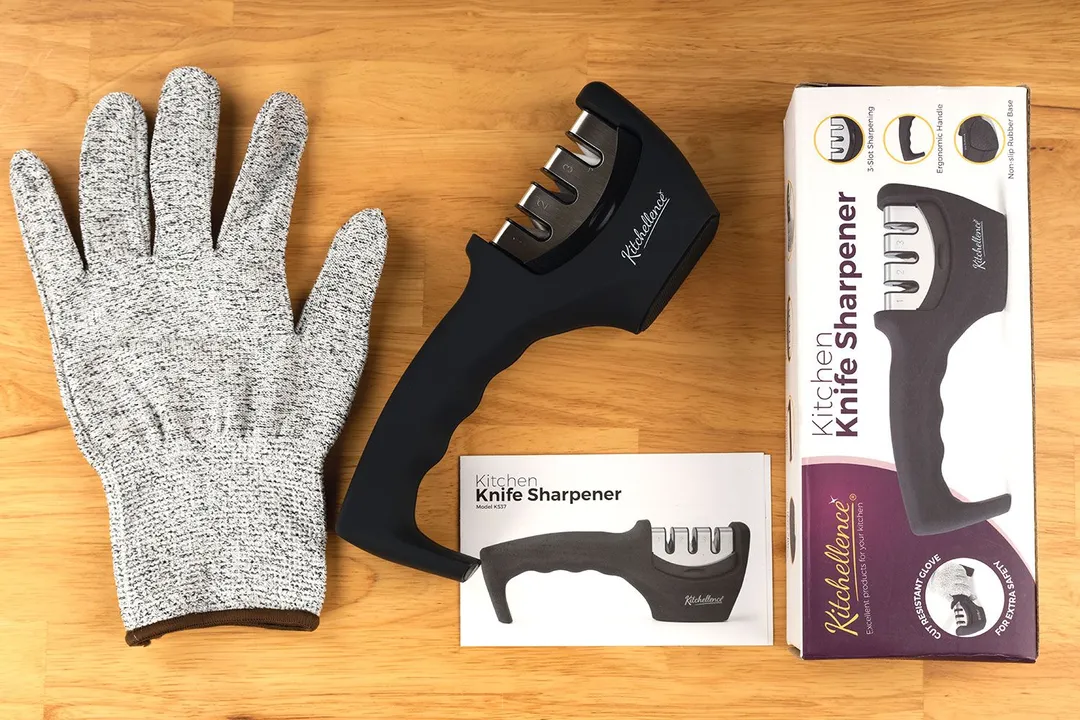 The Kitchellence knife sharpener, its package box, instruction manual, and included safety glove