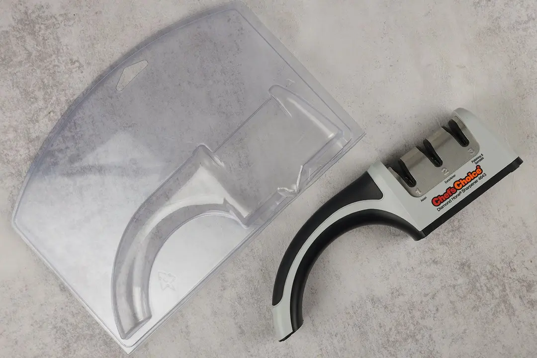 The Chef’s Choice manual knife sharpener next to its plastic case