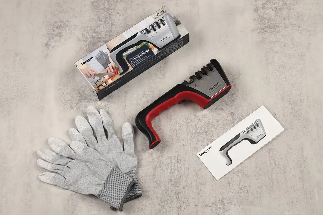 The Longzon knife sharpener lying next to its package box, instruction leaflet, and two gloves