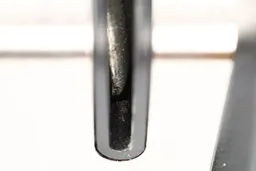 The coarse slot on the Priority Chef sharpener, with metal dust and part the diamond coated abrasive disc shown