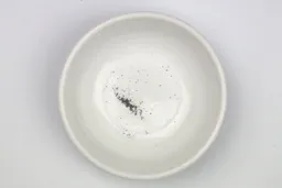 A bowl containing metal sharpening residue