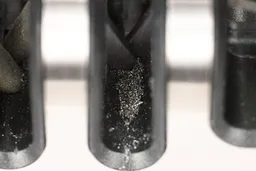 Medal dust on the abrasive slots of the Mueller steel knife sharpener