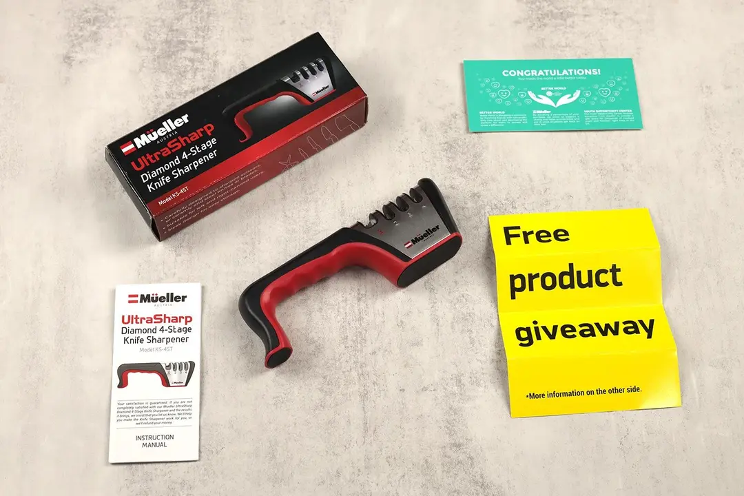 The Mueller 4-stage knife sharpener lying next to its package box, user guide, and promotion leaflets
