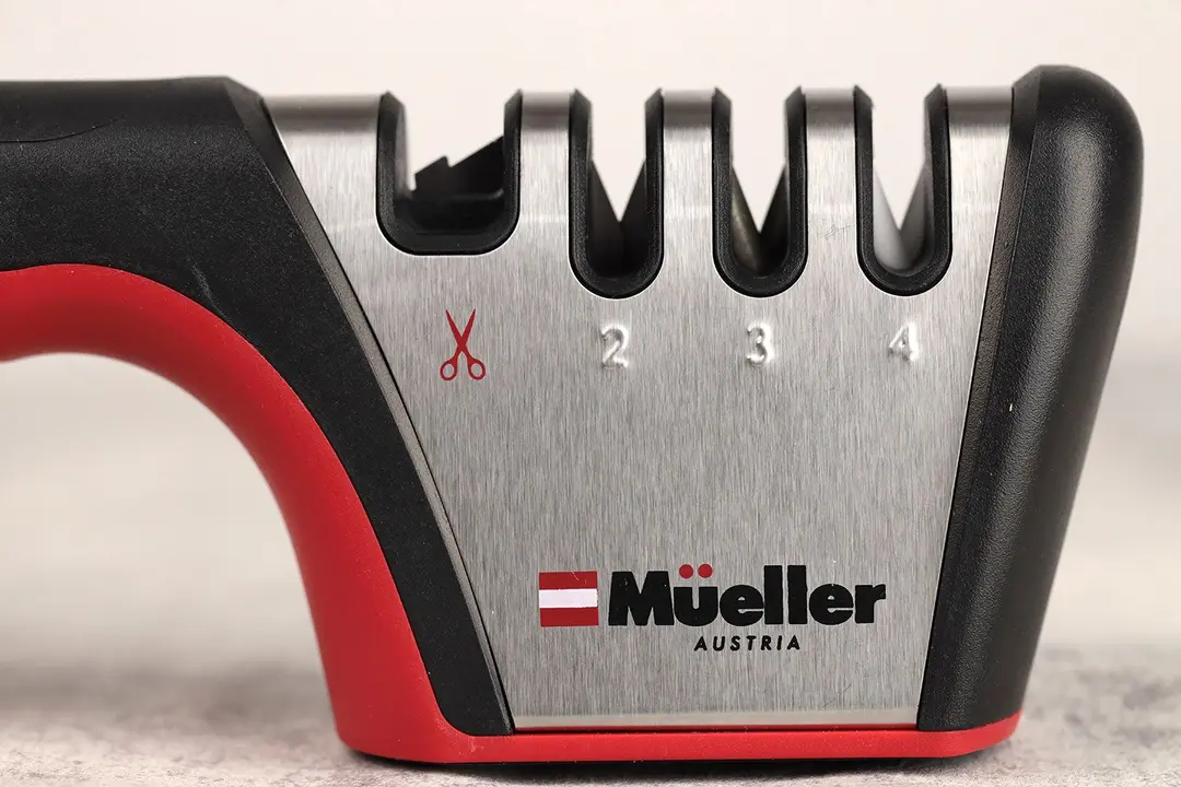 The working section of the Mueller with 4 abrasive slots on a frame and part of its handle and base