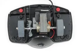 The inside of the Presto Eversharp knife sharpener with its motor and stone wheels, viewed from top