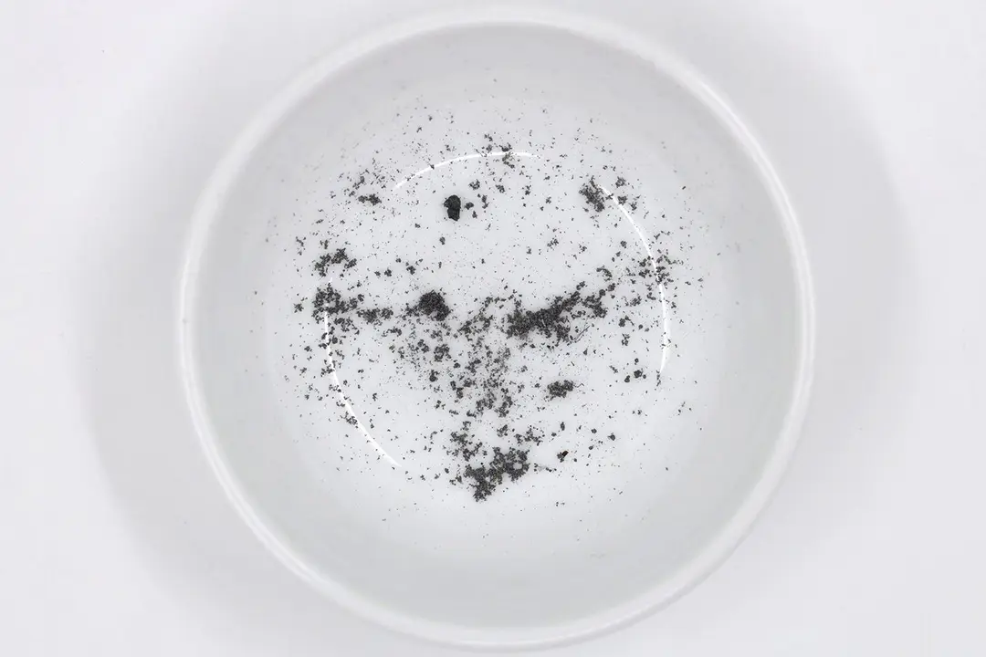 Sharpening residue as metal dust in a white bowl