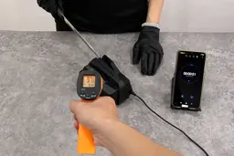 Knife being sharpened with the Work Sharp CPE2, a hand holding a thermometer, and a timer phone screen
