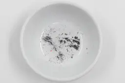 Metal residue in a bowl after sharpening a knife with the Mueller KSE-24 electric sharpener