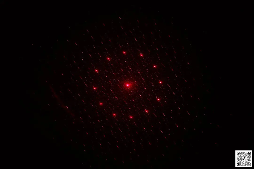 The red, 13-point pattern of the laser emitter of the Mecurate IR thermometer in a dark room.