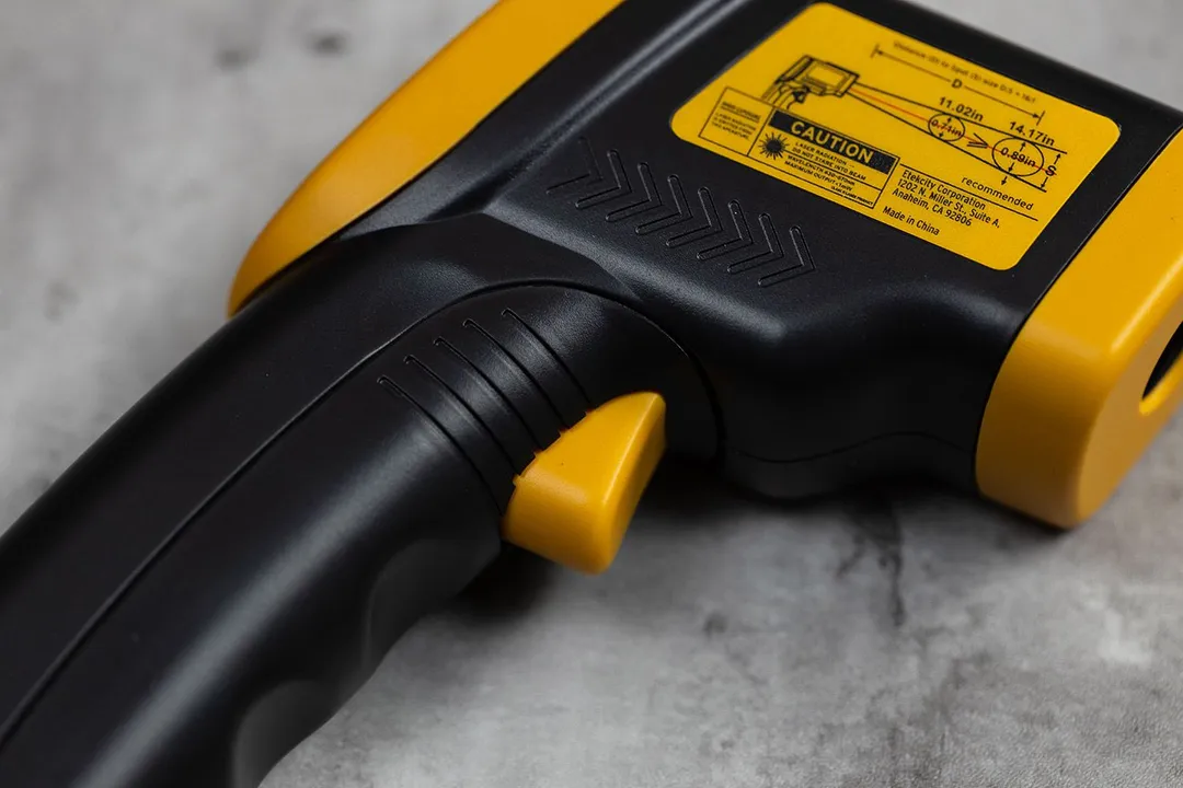 A close-up view of the trigger of the Etekcity Lasergrip 800 IR thermometer.
