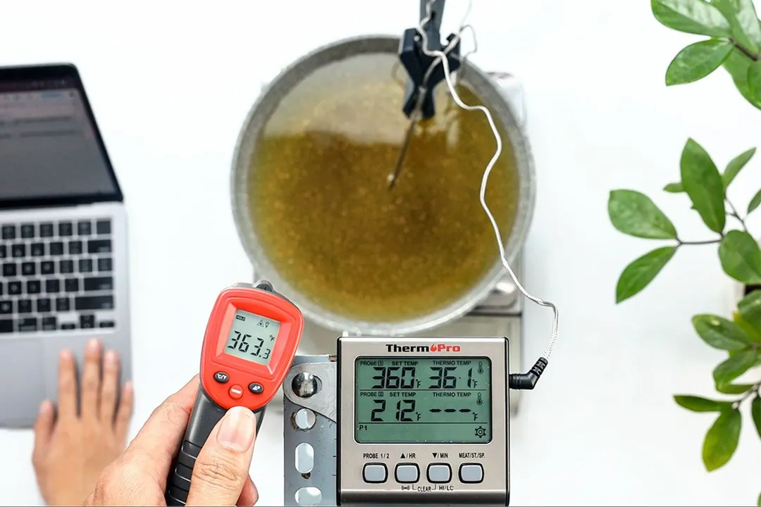 The Eventek GM550 is being used by a reviewer to measure the temperature of hot oil. The screen reads 363.3°F.