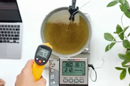 The Helect IR thermometer measuring the temperature of boiling from away 12 inches away. The screen displays 367.5°F.