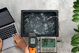 The Klein Tools IR1 measuring an ice bath from a distance of 12 inches, with the screen showing 29.1°F.
