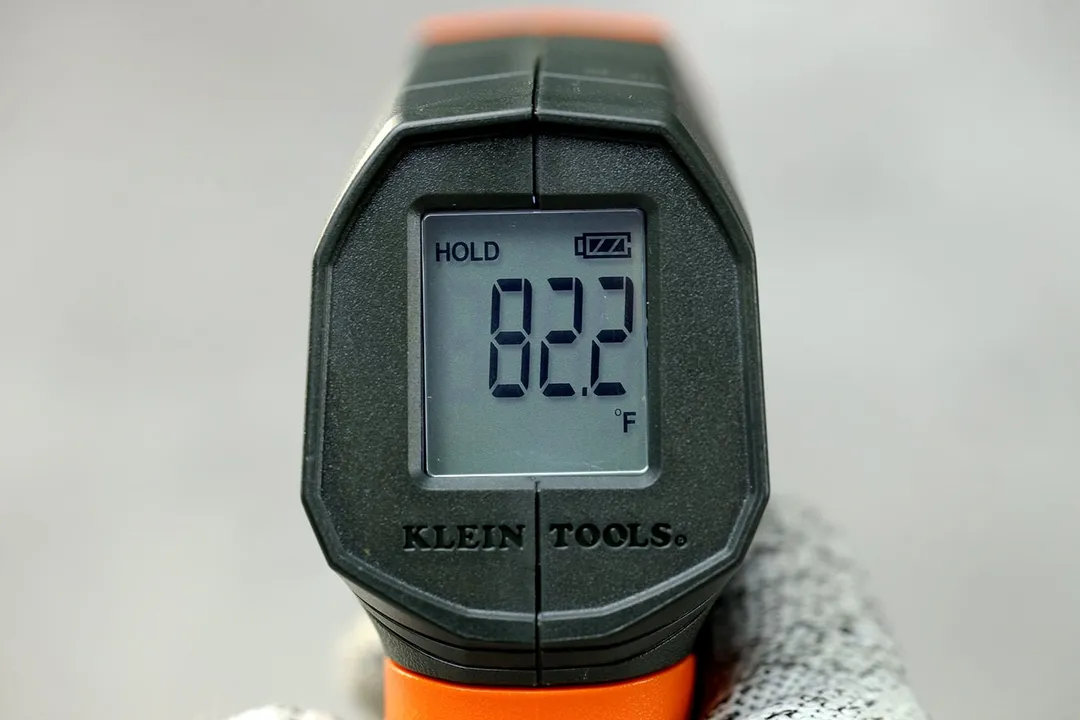 A close-up of the backlit LCD panel at the back of the Klein Tools IR1 thermometer. The screen is displaying “84.9°F.”