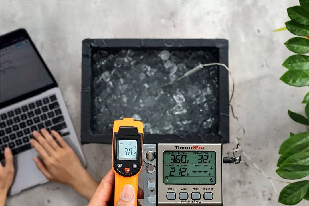 A reviewer is using the Lasergrip GM400 to measure the surface temperature of an ice box from a distance of 12 inches. The screen shows 38.3°F.