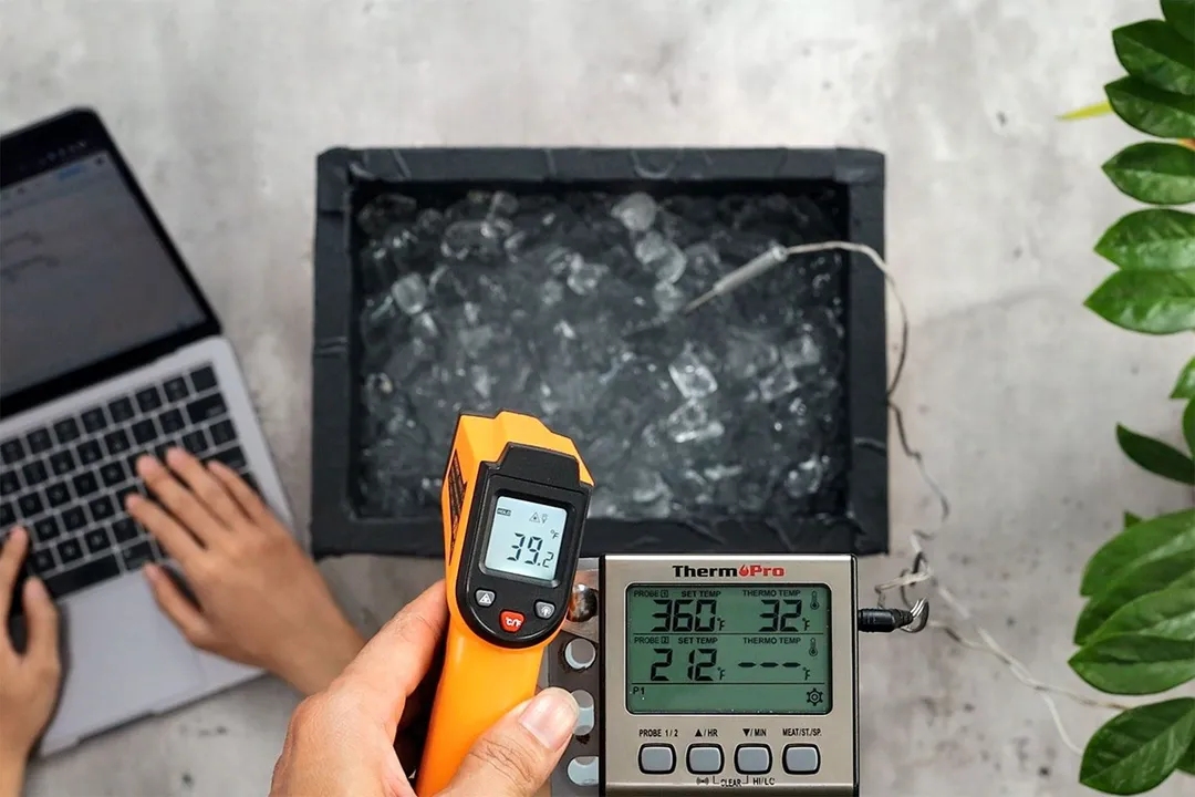 A reviewer is using the Lasergrip GM400 to measure the surface temperature of an ice box from a distance of 16 inches. The screen shows 39.2°F.