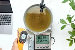 The Lasergrip GM400 measures the surface temperature of a pan of cooking oil from 12 inches away. The screen reads 370.5°F.