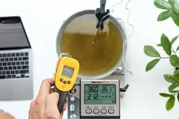 The Smart Sensor AS530 measures the temperature of an oil vat from 16 inches away. The screen reads 366.6°F.