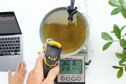 The Sovarcate HS960D measuring the temperature of a pan of cooking oil from 16 inches away. The screen reads 369°F.