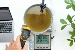The Sovarcate HS960D measuring the temperature of a pan of cooking oil from 12 inches away. The screen reads 373°F.