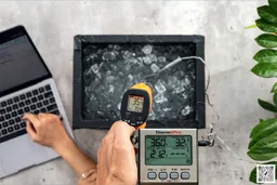 The ThermoPro TP-30 is used to scan the temperature of an ice chest from 16 inches away. The screen reads 35.4°F.