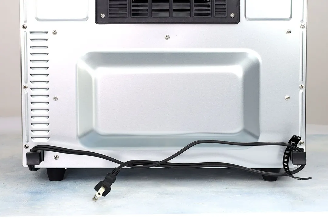 A two-pronged plug power cord. In the background is the Cuisinart TOA-60 Convection Toaster Oven Air Fryer.