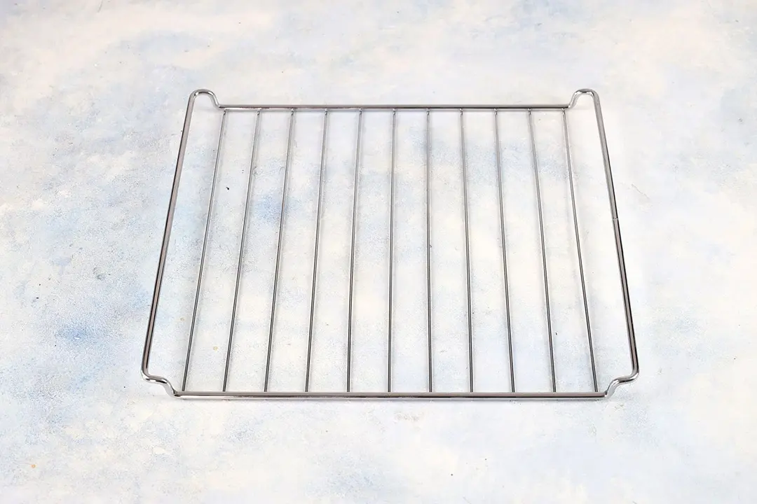 A stainless steel baking rack of the Cuisinart TOA-60 Convection Toaster Oven Air Fryer on a white background.