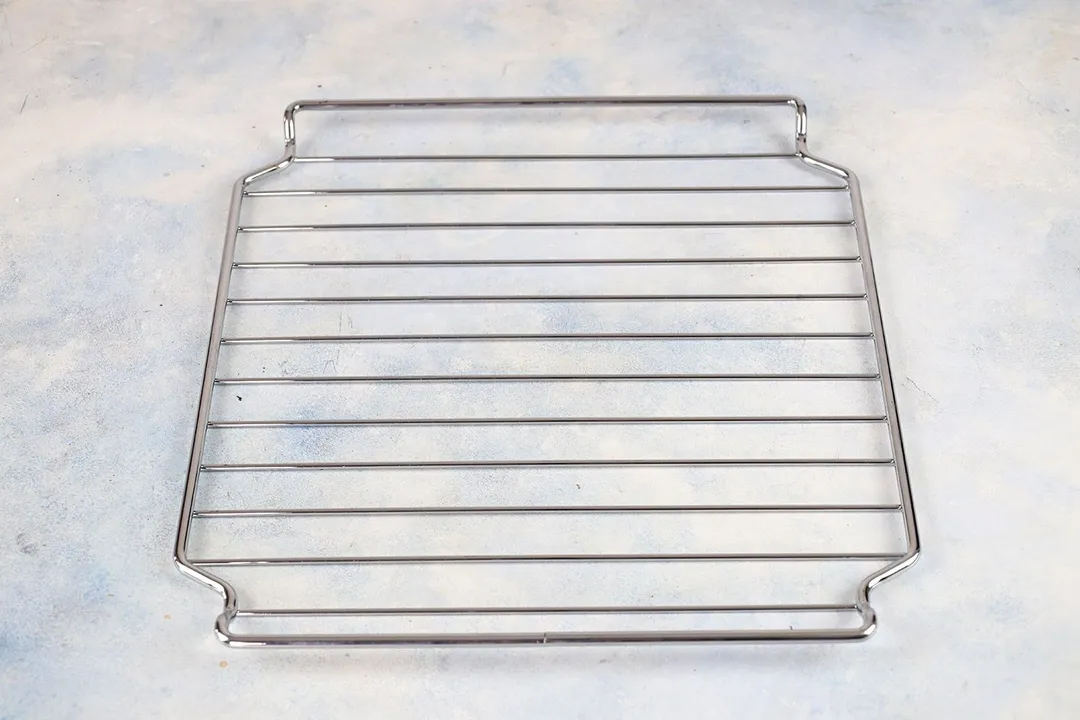A stainless steel baking rack of the Instant Omni Plus 18L 10-in-1 Air Fryer Toaster Oven on a grey background.